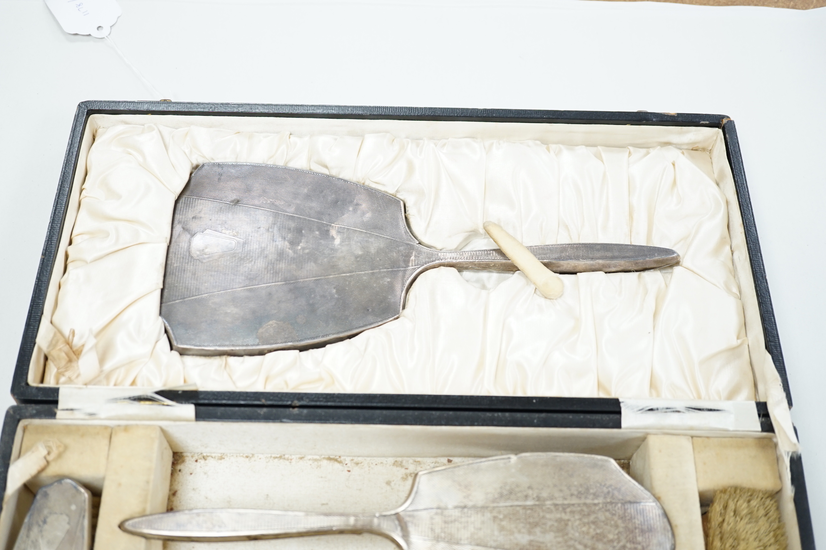 A 1930's cased engine turned silver mounted six piece mirror and brush set, by William Neale & Son Ltd.